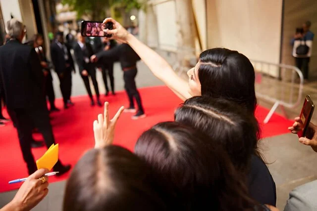 influencer taking pictures with her and fans