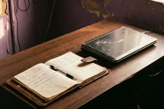 laptop and journal - my workspace after hitting rock bottom and rebuilding my life from scratch